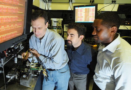 IBM Scientists (L to R) Yurii Vlasov, William Green and Solomon Assefa unveiled a new CMOS Integrated Silicon Nanophotonics chip technology that integrates electrical and optical devices on the same piece of silicon, enabling computer chips to communicate using pulses of light (instead of electrical signals). PHOTO CREDIT: Bob Goldberg/Feature Photo Service
